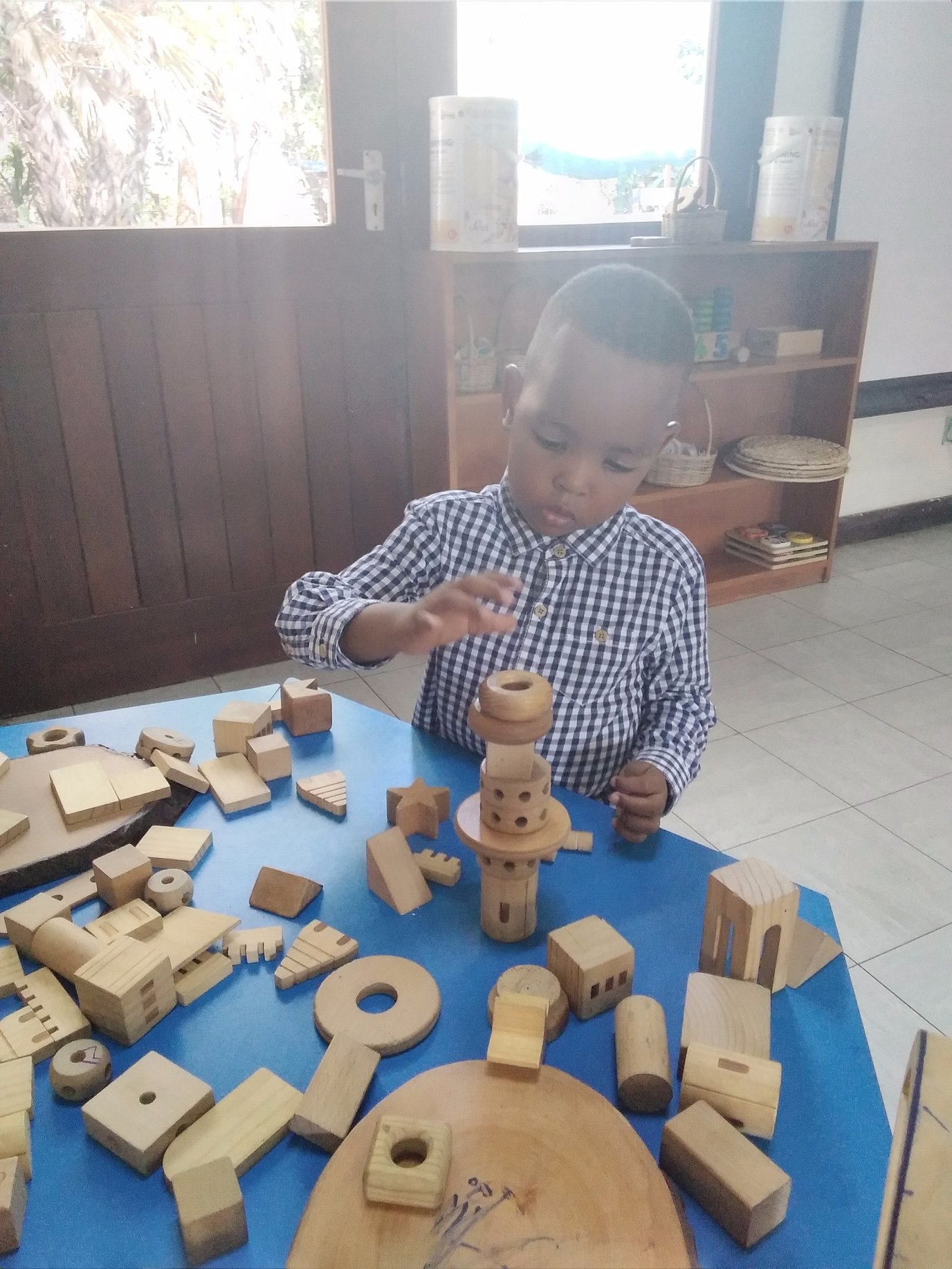 Amir is stacking block to make a tower.jpg